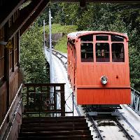 Pixwords The image with bus, train, tracks, mountain, red, car Gunold Brunbauer (Gunold)